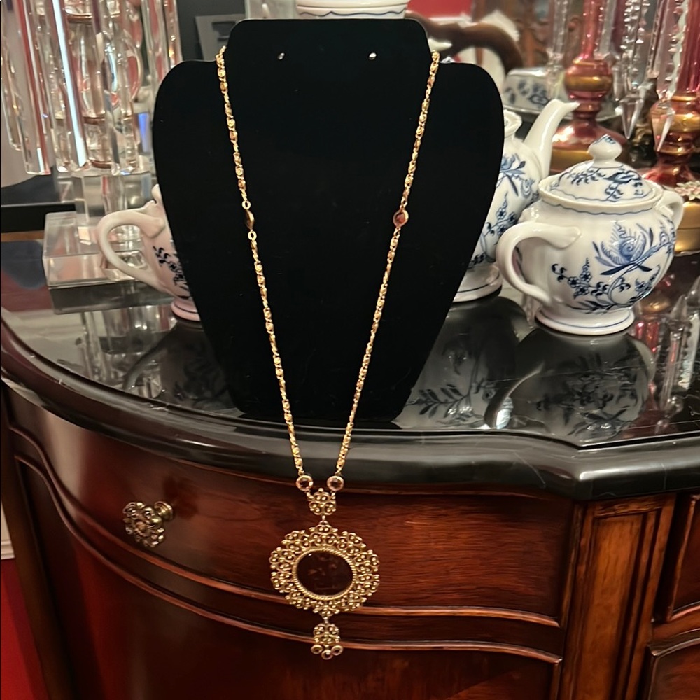 Gold Necklace with Circular Pendant and Shimmering Details